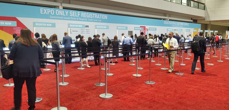 Attendees line up to register for an event