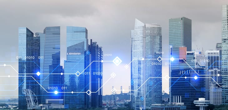 Skyline of modern skyscrapers with a digital overlay.