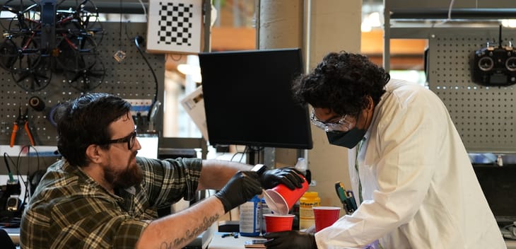 Two engineers work on a project in BRINC's office.