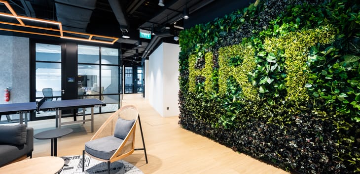 Hudson River Trading's office. On the wall is a hedge with "HRT" on it.