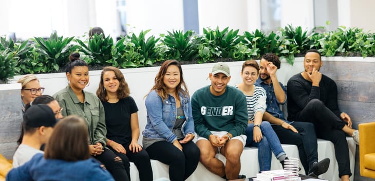 Photo of Foursquare employees gathered on a couch.