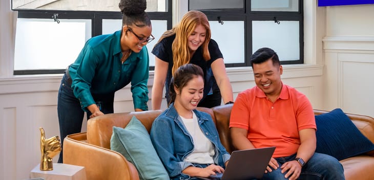 SoFi team members sitting together on a couh