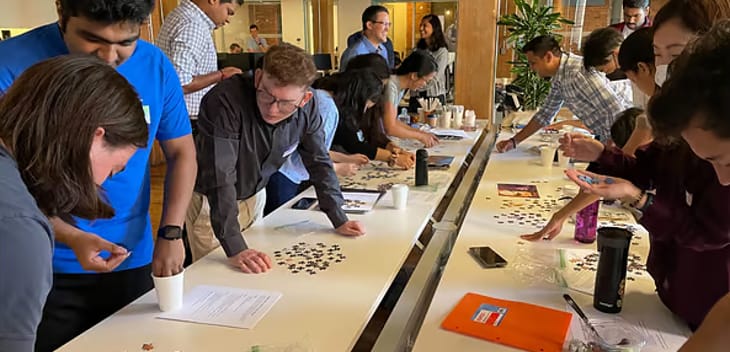 Cohere Health team members work on a group puzzle.