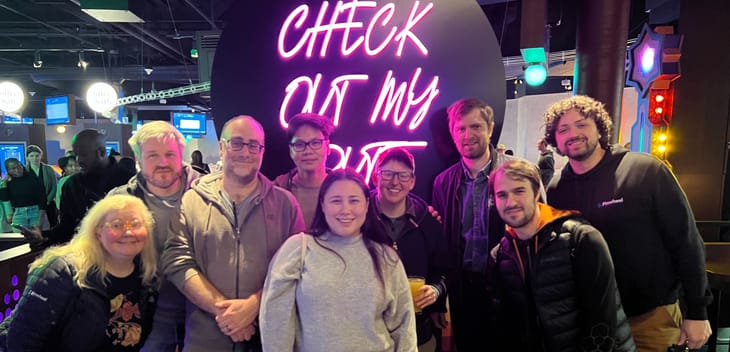 Pinwheel team members posing for a group photo while at a team outing