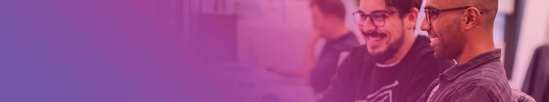 Image shows two people sitting at a computer