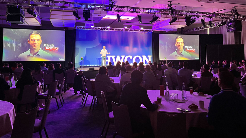 Robin's CEO speaking on stage at a conference.