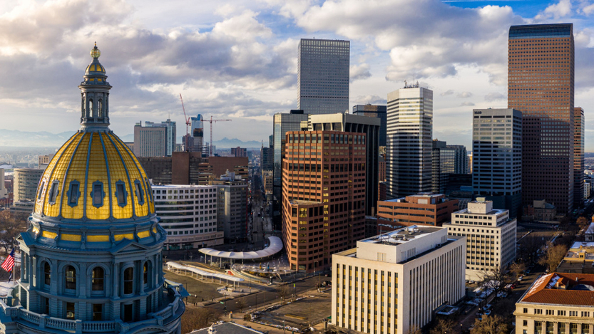 A view of the Colorado state capitol building and Denver skyline.