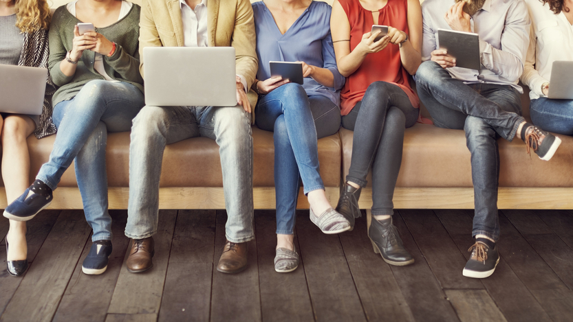 People consuming media on phones, tablets and laptops.