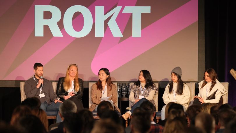 ROKT team members speaking on a panel. 