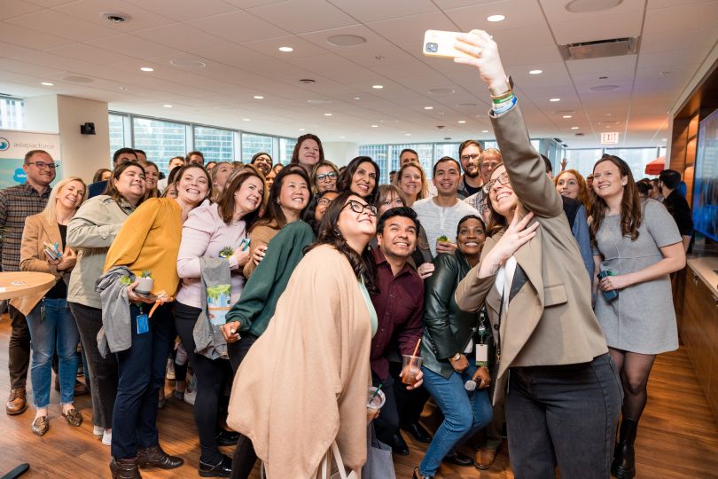 Members of the Salesforce team take a group selfie.