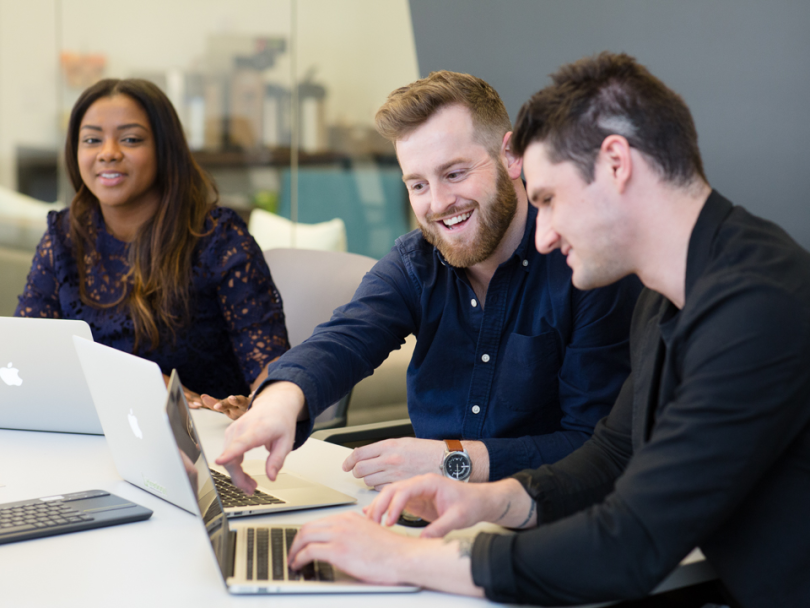 Brett Kirhofer laughs with coworkers