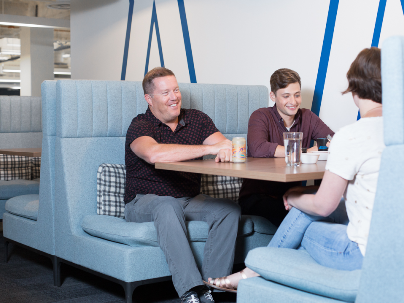 Brad Burke chats with coworkers