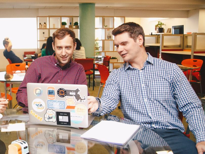 Jackson Brewer of Toast's sales team collaborates with a colleague