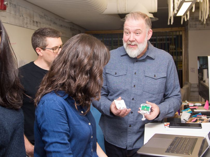 Wade Devers shows employees a design