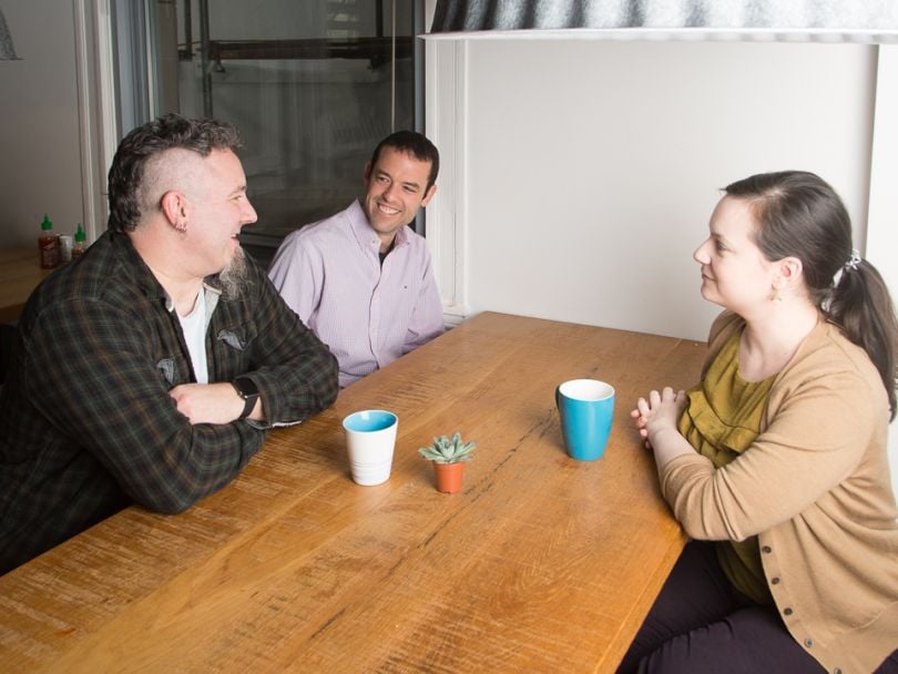Steve Gardos chats with coworkers in the kitchen