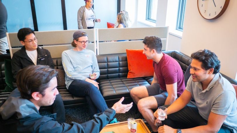 Wolverine Trading employees gather in a communal office space. 