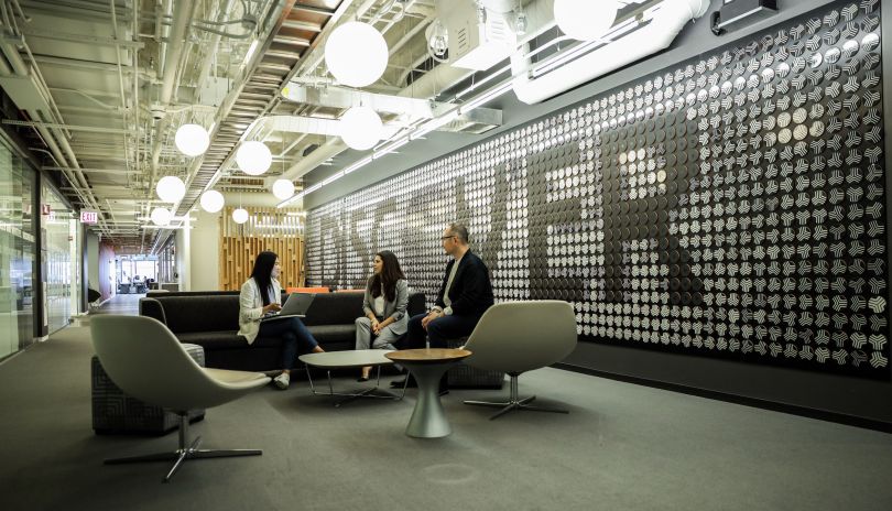 Discover team members gather in a communal area.