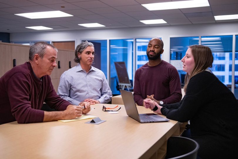 Four Adage Technologies workers in a meeting