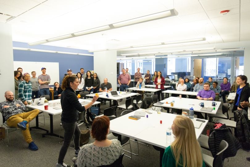 A group of 8th Light employees holding a meeting.