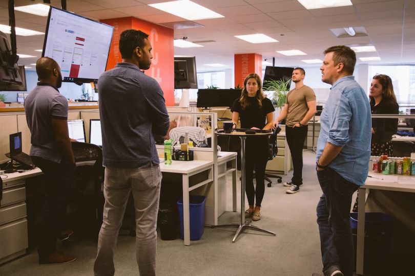 Adage Technologies team members chatting in their office