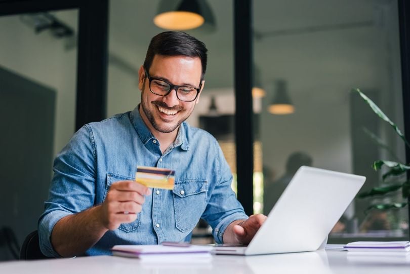  man doing online shopping on a laptop