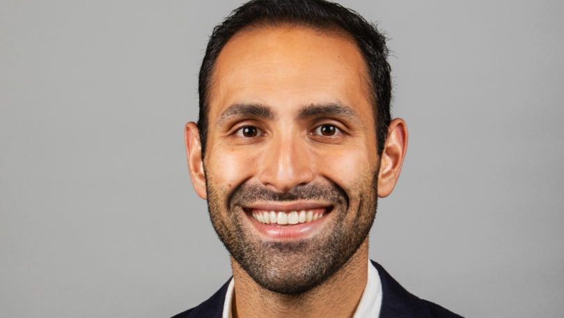 Ali Sabeti, CEO of Zerocater, poses for a photo against a grey background.