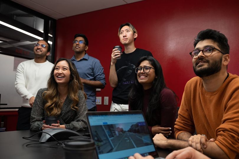AlphaSights team members watching a presentation in a meeting room
