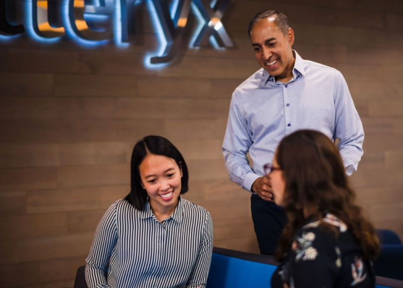 Alteryx colleagues having a team huddle in the office