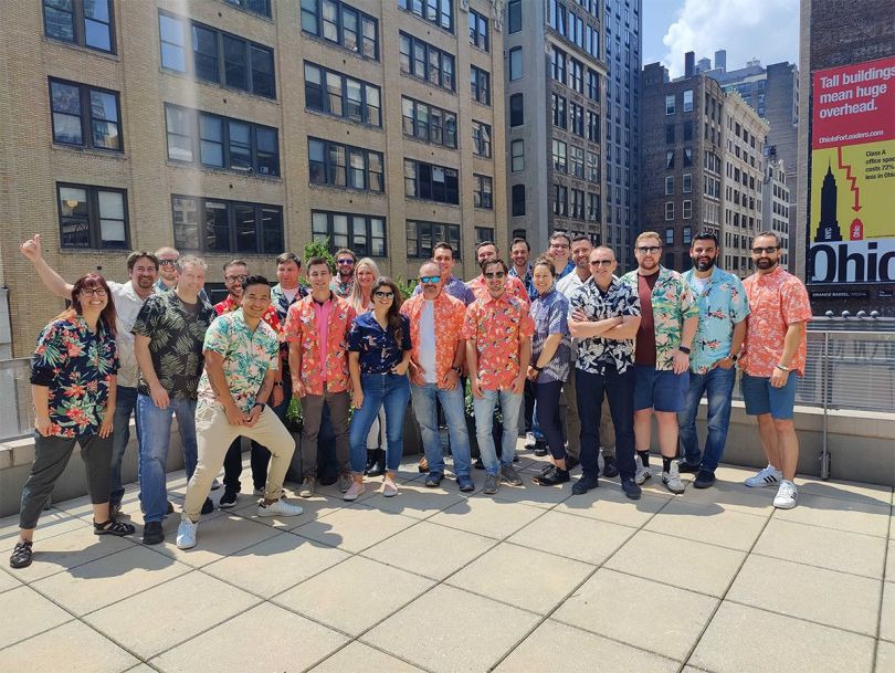 Augury team members wearing aloha shirts on a rooftop patio