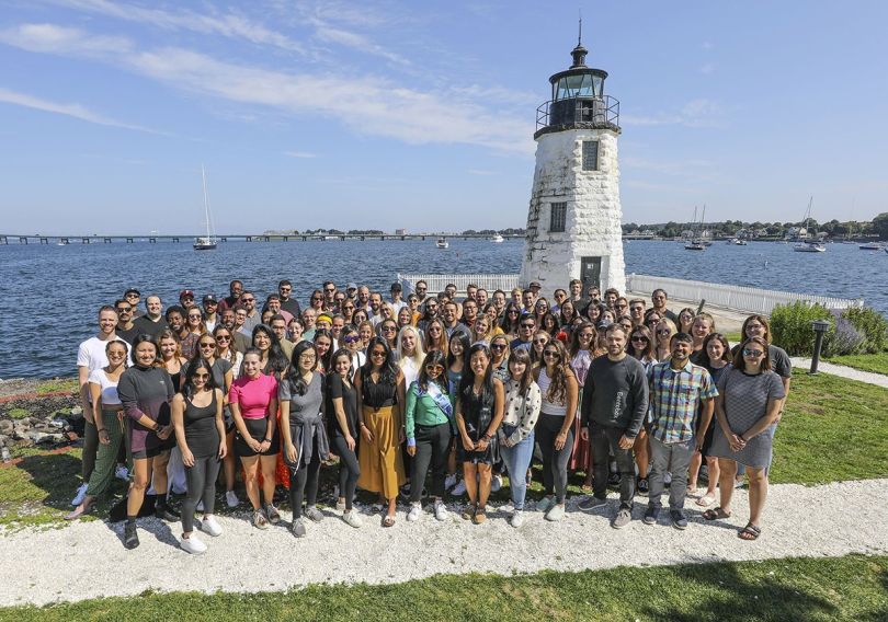 BentoBox group photo outside with a lighthouse and water in the background