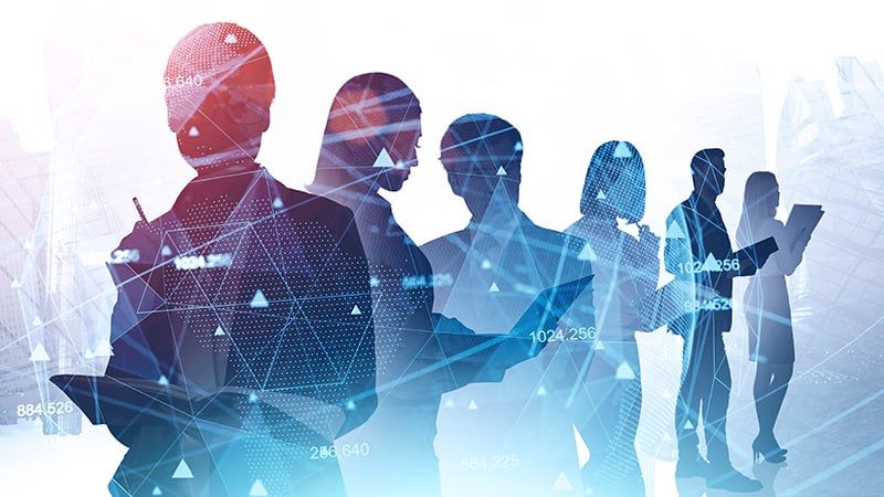 The silhouettes of IT professionals with a graphical overlay