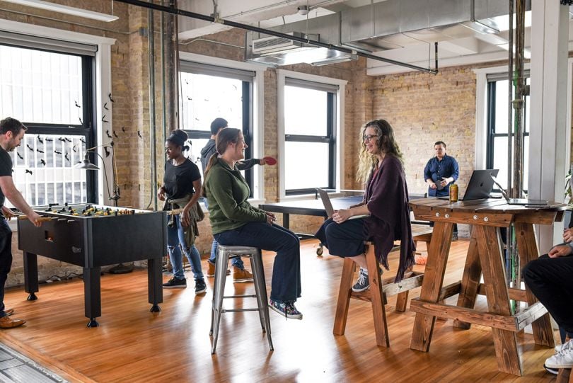 BlackLocus team members in the game room at the office
