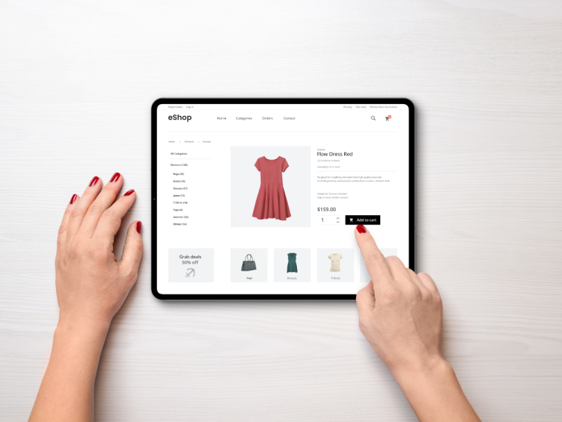A person buying a dress on a tablet
