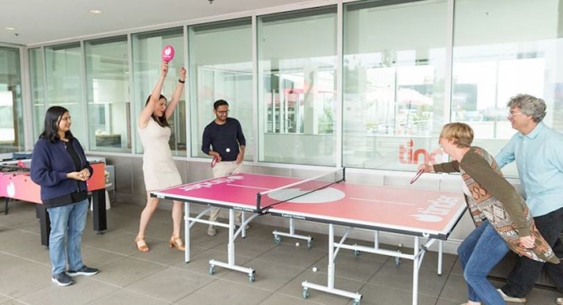 Tinder team playing ping pong