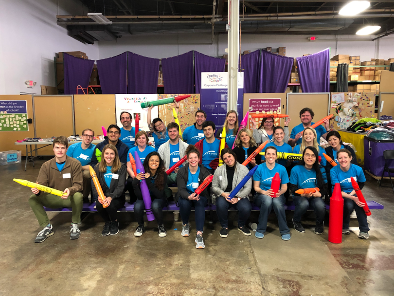 Kyruus group photo with some team members holding giant crayons