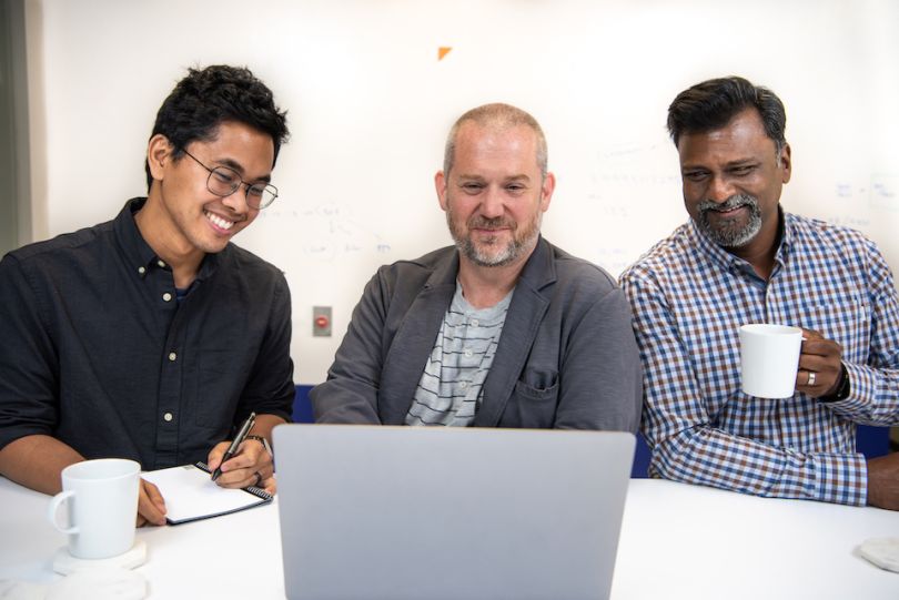 CardX team members working at a computer