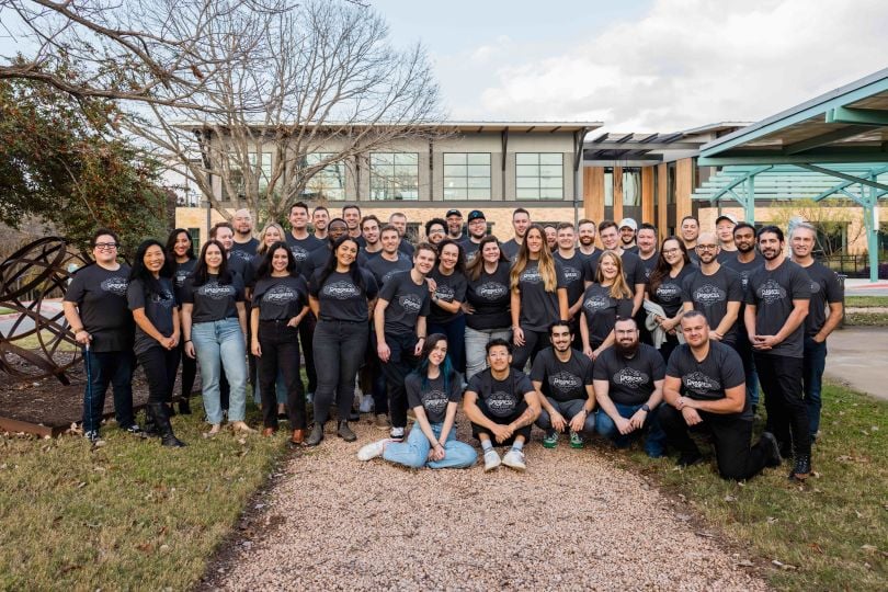 Large group photo of CertifID team outdoors in front of office building