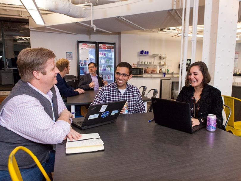 Members of the ClearDATA team collaborating in the office