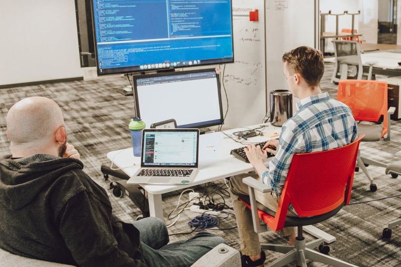 A Cloud Guru team member working on a computer at a desk in the office