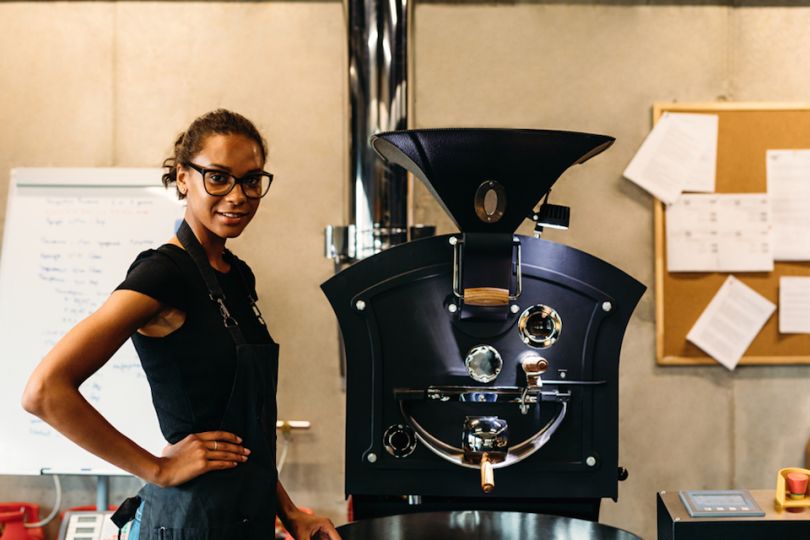 Coffee shop owner next to grinder