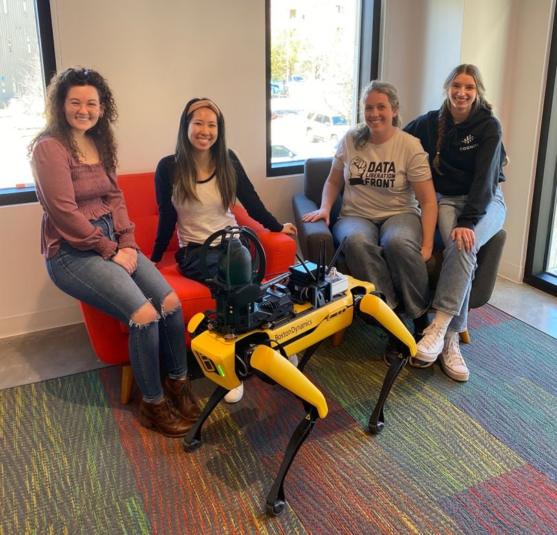 Cognite team in the office with a robot dog