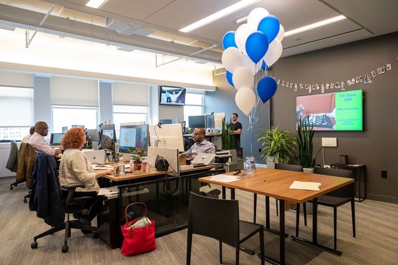 Coinbase office workspace with team members working on computers