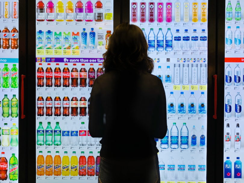 Woman standing in front of Cooler Screen screen