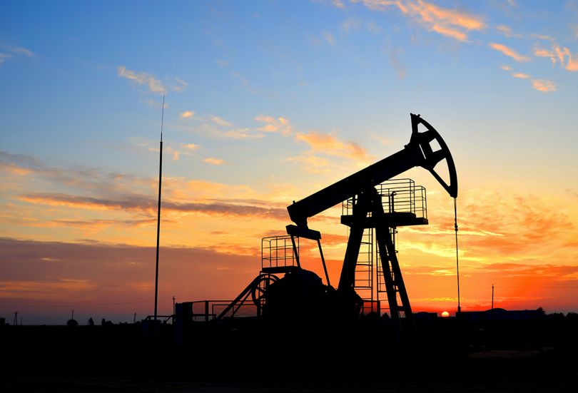 Oil drilling derricks at desert oilfield for fossil fuels output and crude oil production from the ground