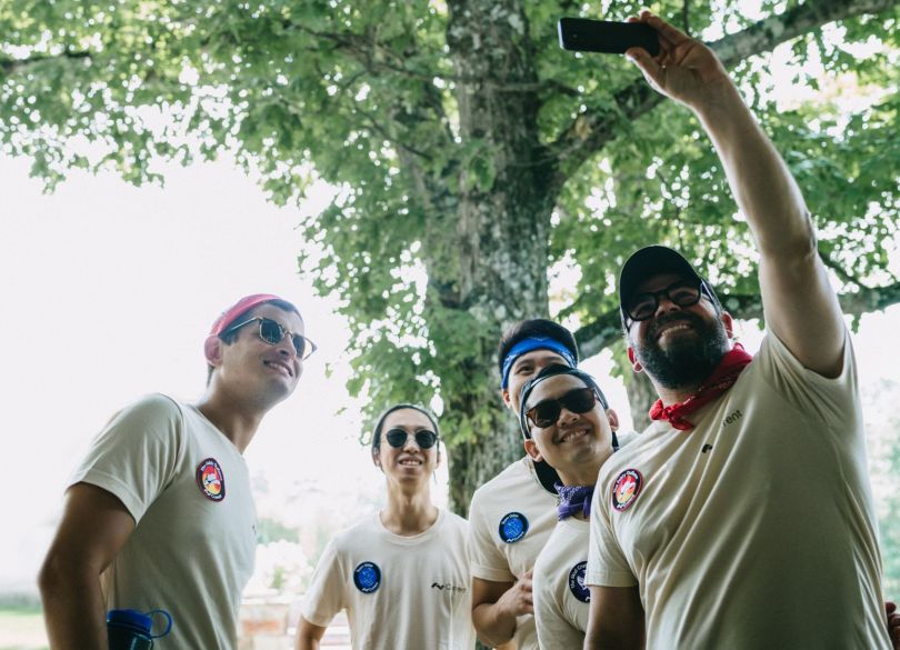 Current team members outdoors taking a selfie