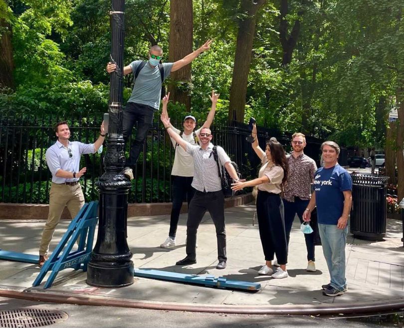 Cutover team members outside with one person on a lampost