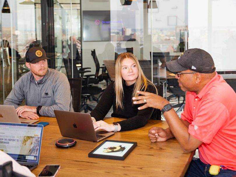 Cybereason colleagues having a team huddle in the office