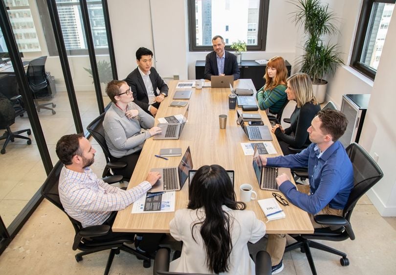 DAS42 team members sitting around a conference table having a meeting