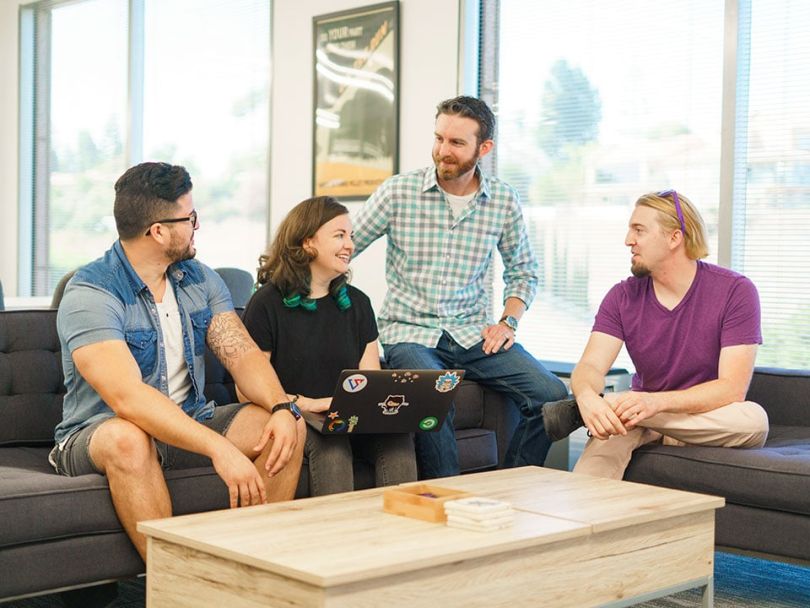 Dan Howard sits with his coworkers