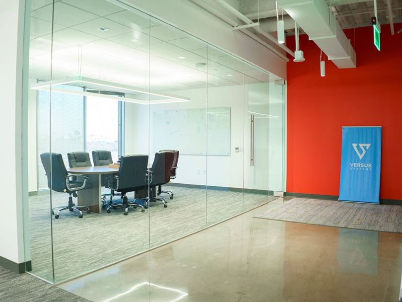 Versus Systems logo and conference room